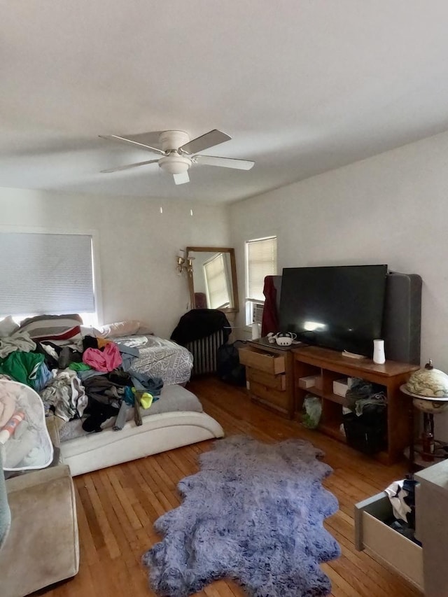 bedroom with ceiling fan and hardwood / wood-style flooring