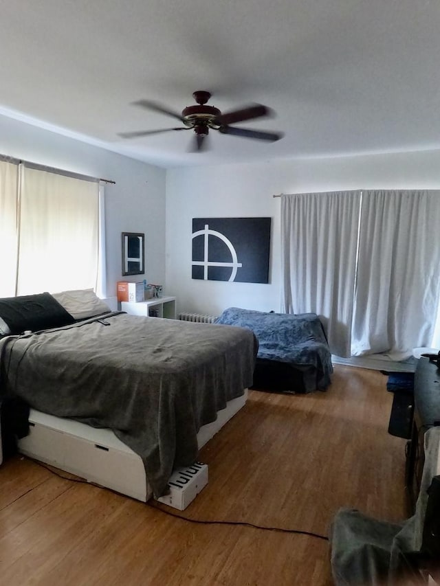 bedroom with light wood-type flooring and a ceiling fan