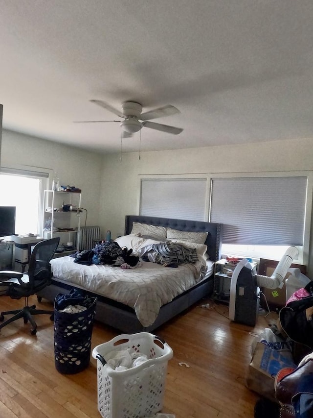 bedroom with ceiling fan and wood finished floors