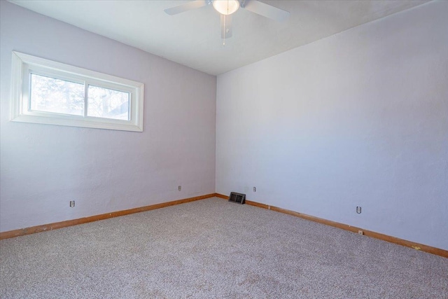 spare room featuring carpet, baseboards, and a ceiling fan