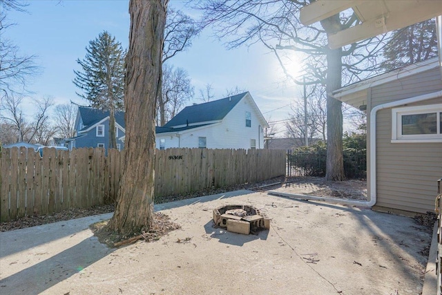 view of yard with an outdoor fire pit and fence