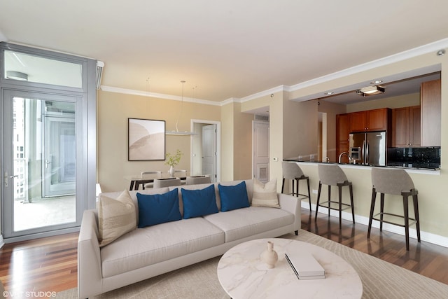 living area featuring ornamental molding, plenty of natural light, and wood finished floors