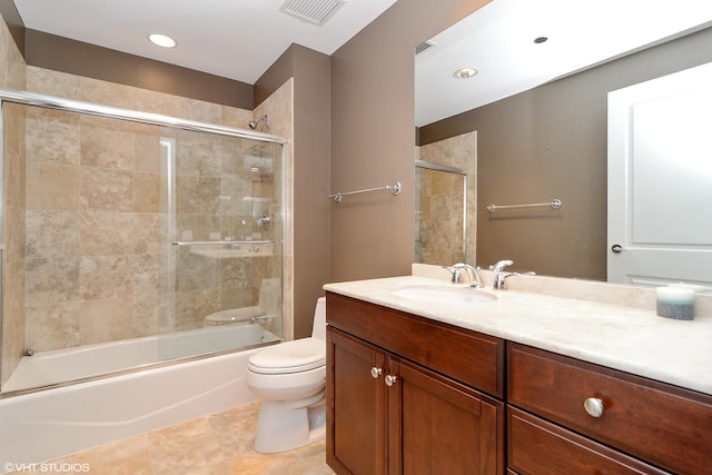 full bath featuring shower / bath combination with glass door, visible vents, toilet, vanity, and tile patterned flooring