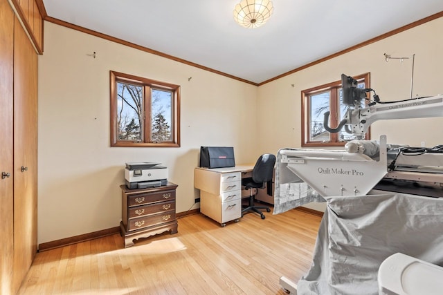 office featuring crown molding, light wood-style flooring, and baseboards