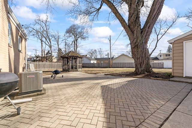 view of patio featuring central AC unit, a grill, and fence