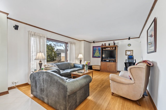 living room featuring baseboards, light wood-style floors, and ornamental molding