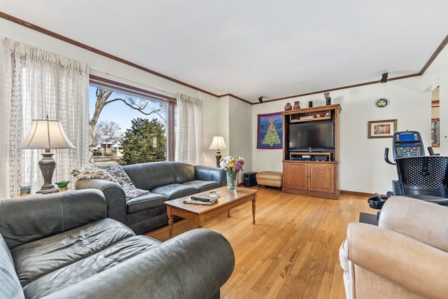 living area featuring baseboards, light wood-style floors, and crown molding