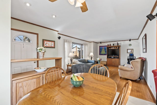 dining space with light wood-type flooring, ornamental molding, recessed lighting, baseboards, and ceiling fan