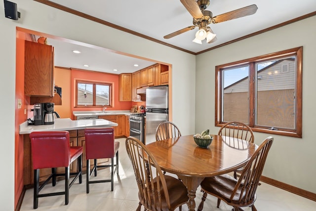 dining area with recessed lighting, baseboards, ornamental molding, and ceiling fan