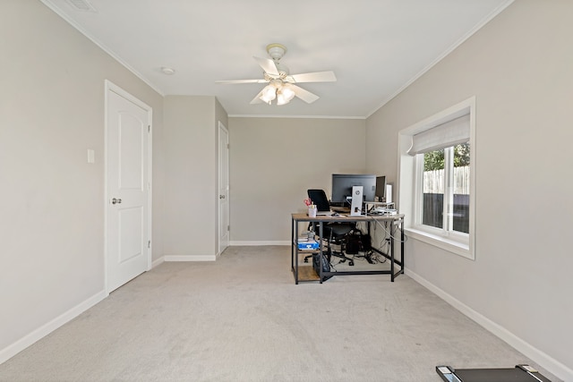 carpeted office space featuring ceiling fan, baseboards, and crown molding