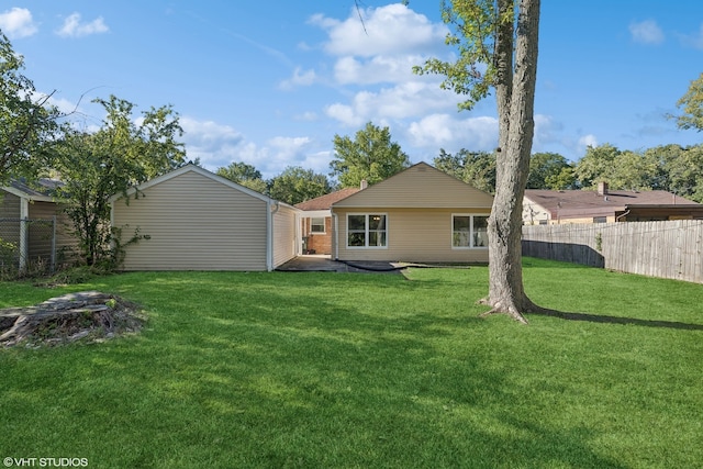 back of property with fence and a yard