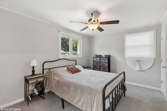 carpeted bedroom with ornamental molding, ceiling fan, and baseboards