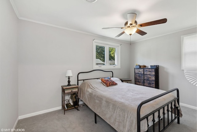 carpeted bedroom featuring ornamental molding, ceiling fan, and baseboards