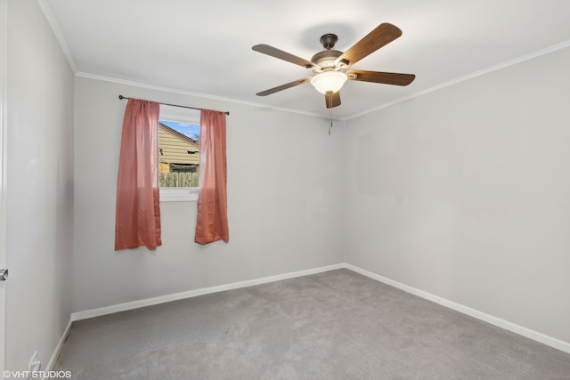 spare room with baseboards, ceiling fan, carpet flooring, and crown molding