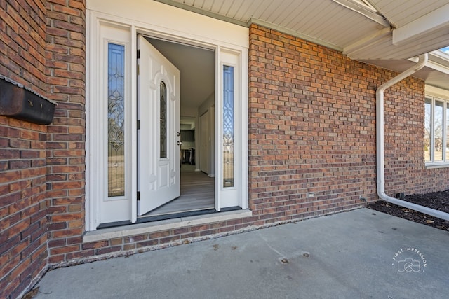 property entrance featuring brick siding