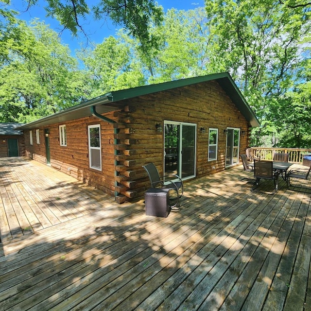 wooden terrace with outdoor dining area