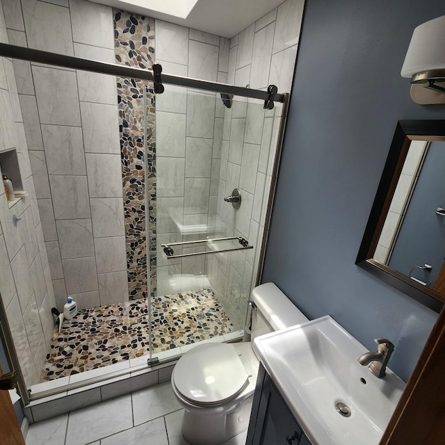 bathroom with a stall shower, marble finish floor, and toilet