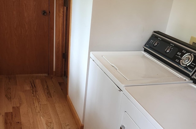 clothes washing area featuring light wood-type flooring, laundry area, and independent washer and dryer