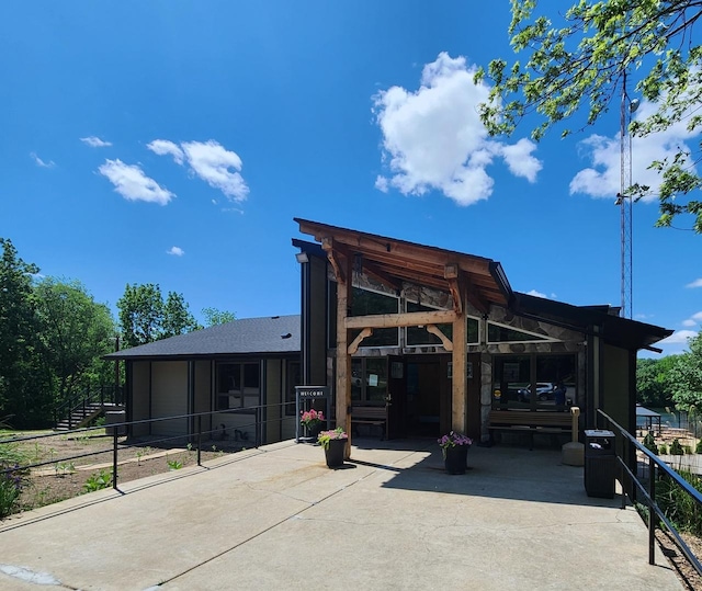 exterior space featuring concrete driveway and a patio