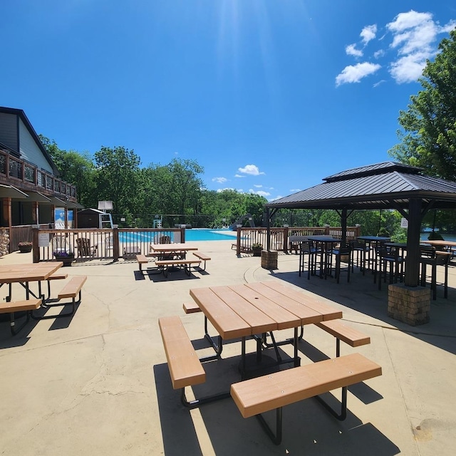 view of property's community with a gazebo, a patio, and a swimming pool