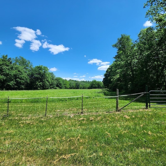 view of yard featuring a rural view and fence