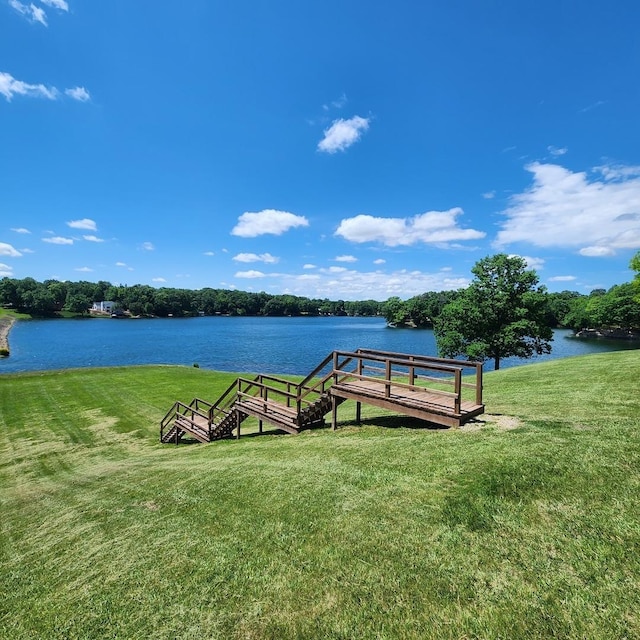 dock area featuring a water view and a yard