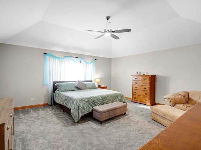 carpeted bedroom with lofted ceiling and baseboards