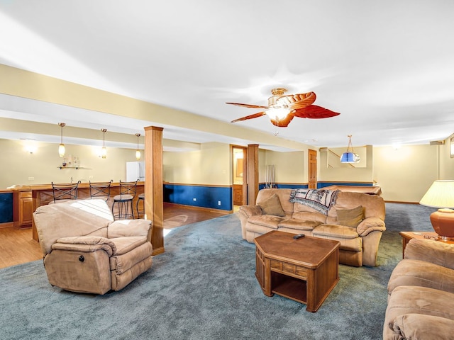 living area with carpet floors and wainscoting