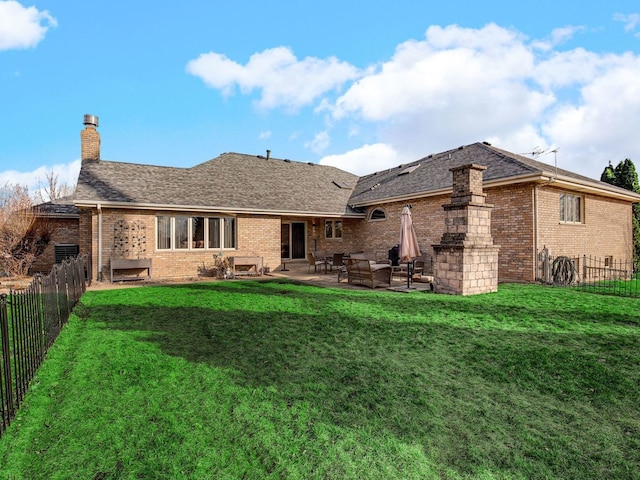 rear view of house with a patio area, a fenced backyard, a lawn, and brick siding