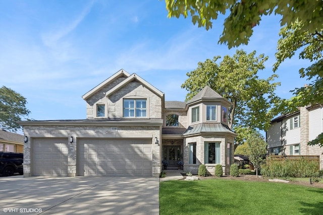 view of front of home with a standing seam roof, a front yard, concrete driveway, and brick siding