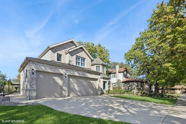 view of front facade with brick siding, driveway, and a front lawn