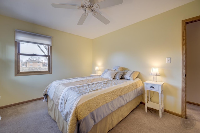 bedroom with light colored carpet, ceiling fan, and baseboards