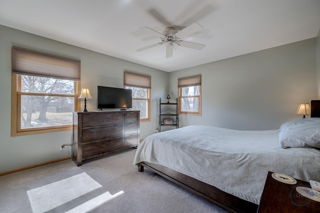 bedroom featuring baseboards, a ceiling fan, and light colored carpet