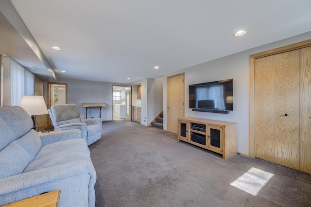 living area featuring carpet floors, stairs, and recessed lighting