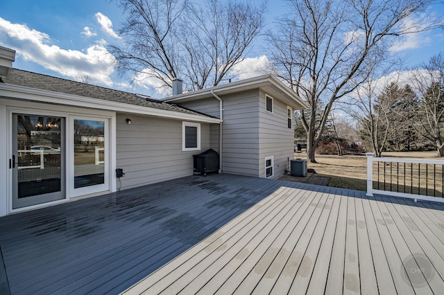 wooden deck with cooling unit and a grill