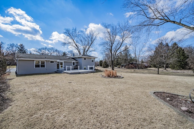 back of house featuring a wooden deck