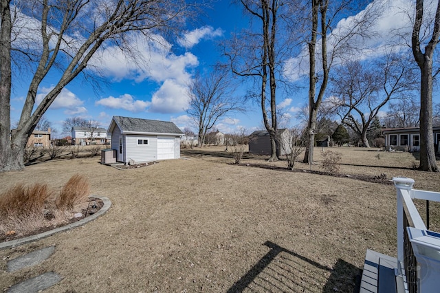 view of yard featuring a storage shed, fence, and an outdoor structure