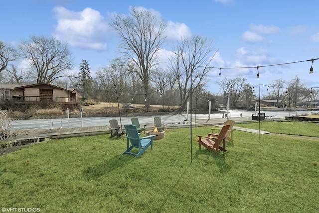 view of yard with fence and an outdoor fire pit