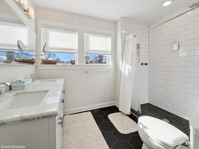 bathroom with tile patterned floors, double vanity, a tile shower, and a sink