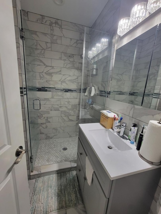 8240 S Wolcott Ave, Chicago, IL 60620 - bathroom featuring a stall shower, vanity, and tile walls