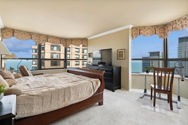 carpeted bedroom featuring ornamental molding and baseboards