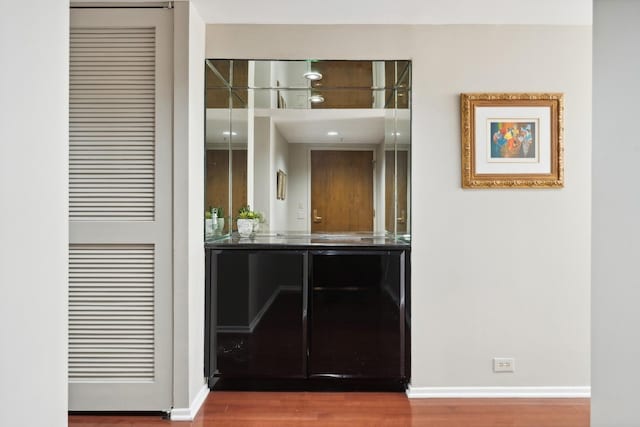 bar featuring baseboards and wood finished floors