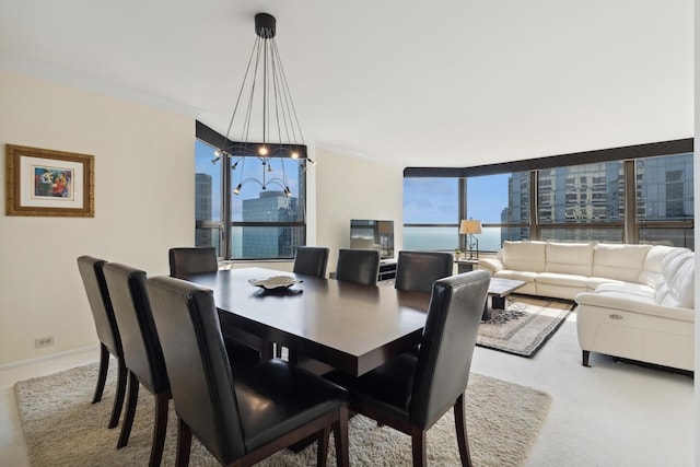 dining area with ornamental molding, floor to ceiling windows, and baseboards