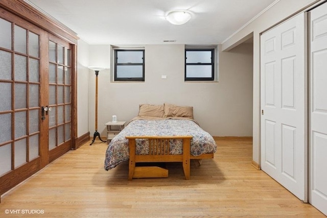 bedroom featuring light wood-style floors and french doors