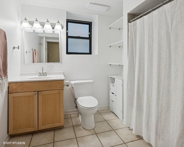 full bathroom featuring toilet, tile patterned floors, baseboards, and vanity