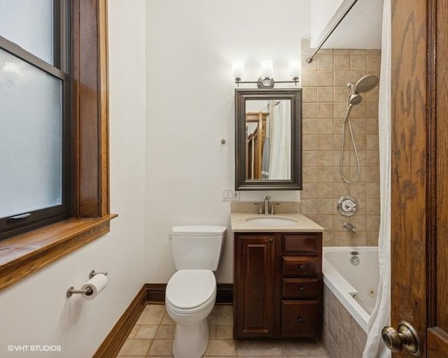 bathroom featuring baseboards, toilet, tile patterned floors, tiled shower / bath combo, and vanity