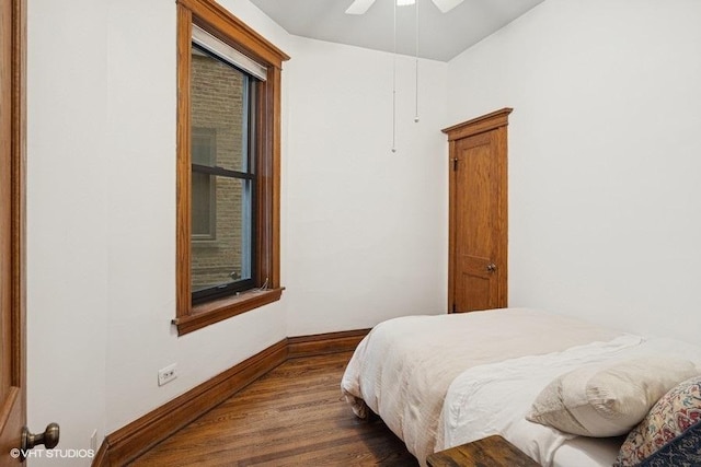 bedroom featuring a ceiling fan, baseboards, and wood finished floors