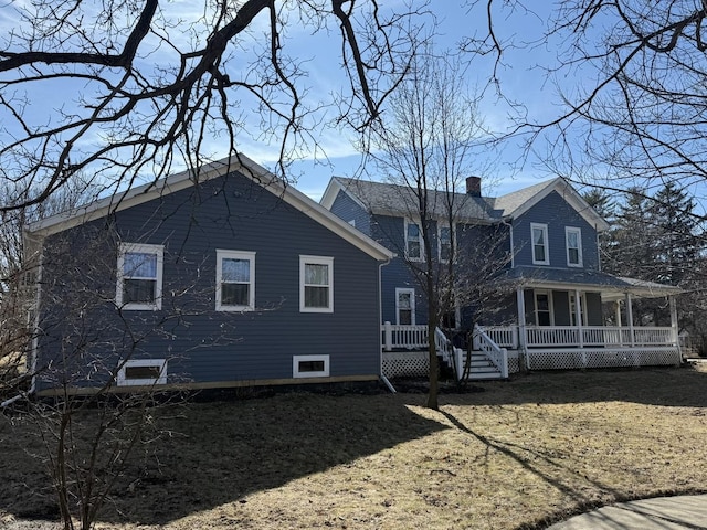 exterior space featuring a chimney and a porch