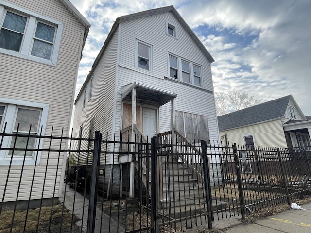 view of front of house featuring a fenced front yard and a gate