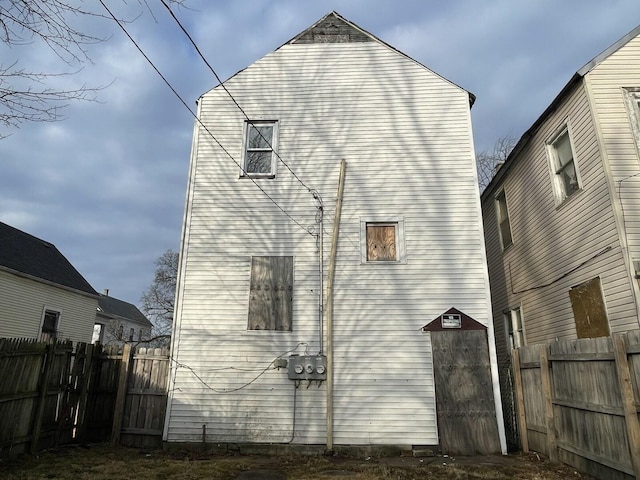 rear view of property featuring fence